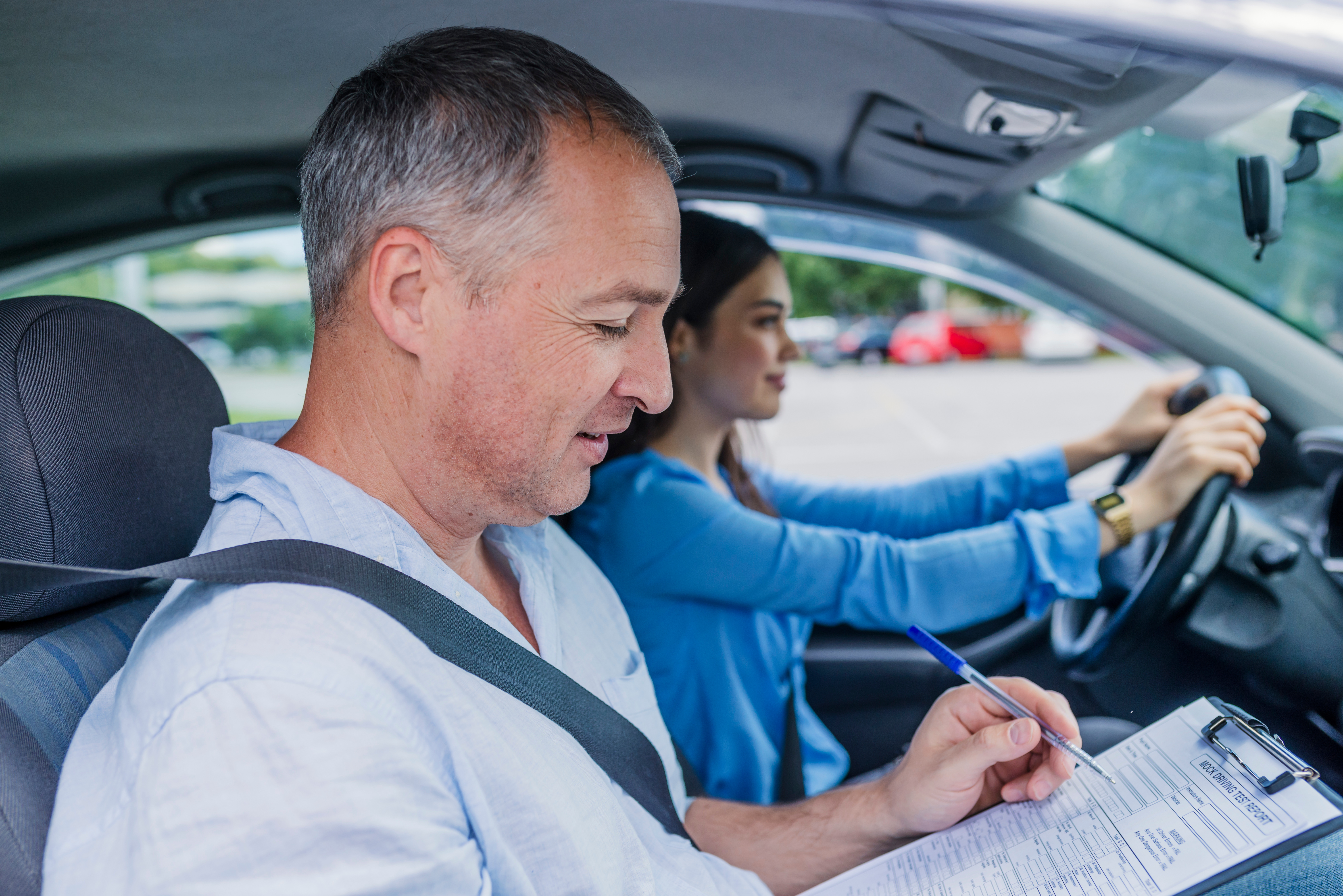 Student driver behind the wheel with instructor